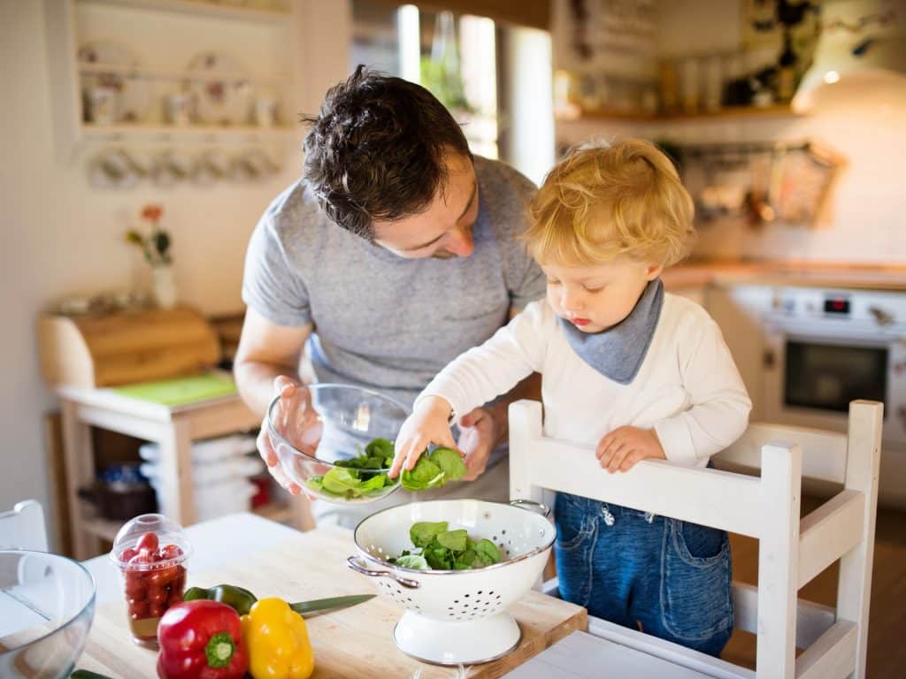 Padre enseña a cocinar a un niño